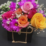 A bouquet of flowers in a purse.