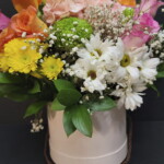 A bouquet of flowers in a white vase.