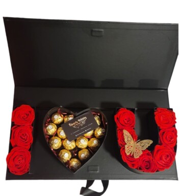 A heart shaped box of chocolates and roses